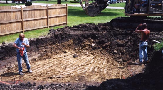 Backhoe excavating the site for an inground pool