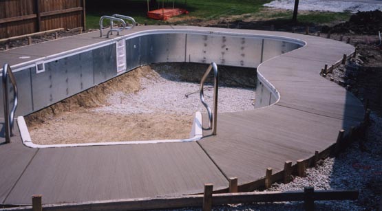 Concrete decking being poured around the pool