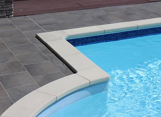 Finished concrete pool decking around a swimming pool